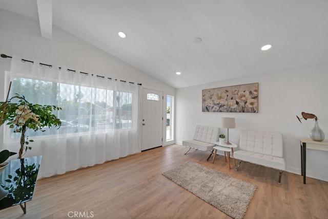 entrance foyer with light wood-type flooring and vaulted ceiling