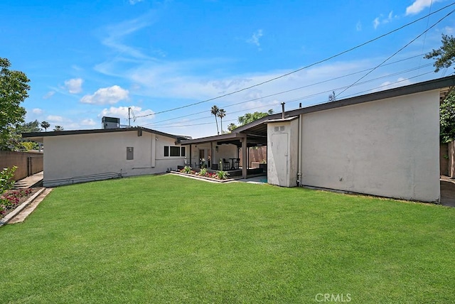 back of house featuring a lawn