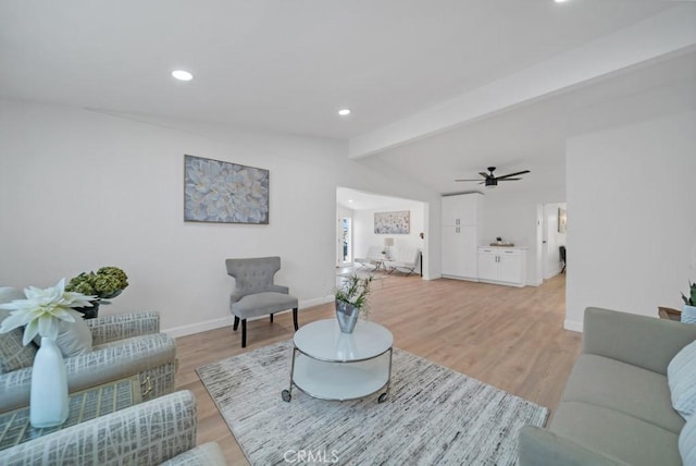 living room featuring ceiling fan, light wood-type flooring, and vaulted ceiling with beams