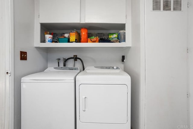 clothes washing area with washer and clothes dryer