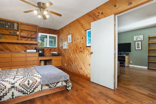 bedroom featuring ceiling fan, dark wood-type flooring, and wooden walls