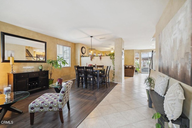 dining area featuring light tile patterned flooring and a healthy amount of sunlight