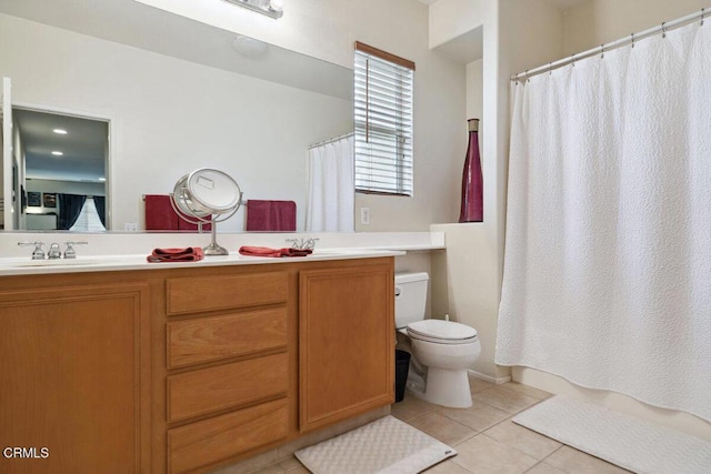 bathroom with tile patterned floors, vanity, toilet, and a shower with shower curtain