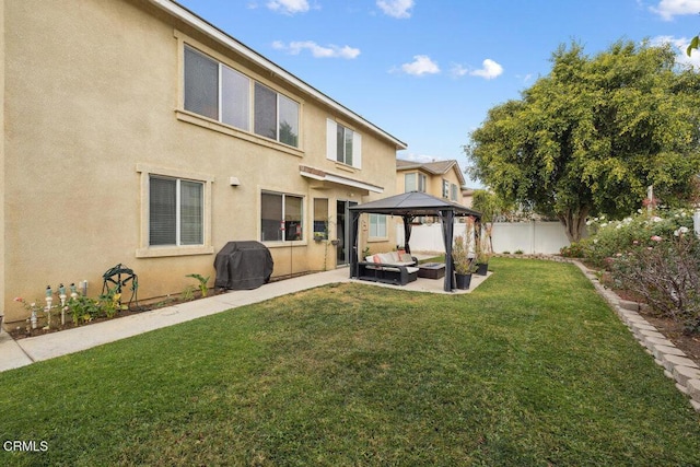 back of property featuring a gazebo, a patio, and a yard