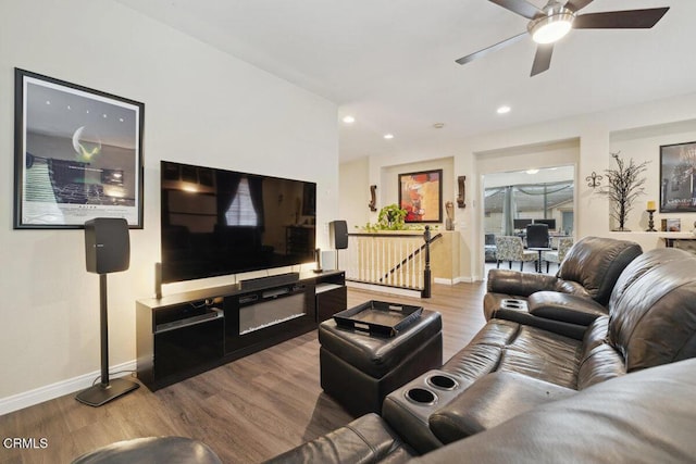 living room featuring ceiling fan and light hardwood / wood-style flooring