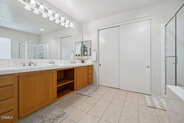 bathroom featuring vanity, tile patterned floors, and a shower with door