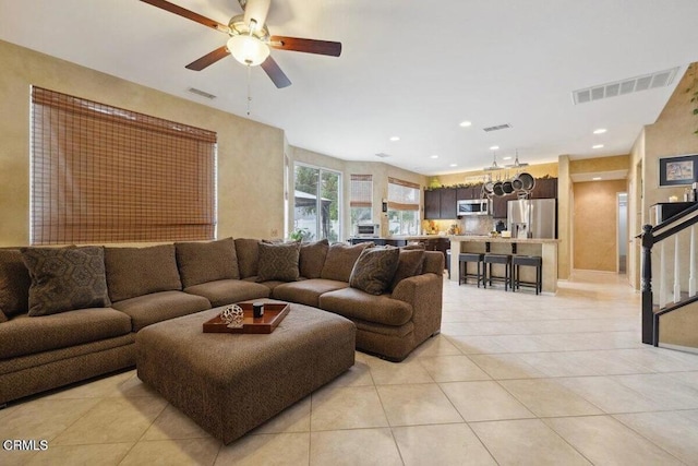 living room with ceiling fan and light tile patterned flooring