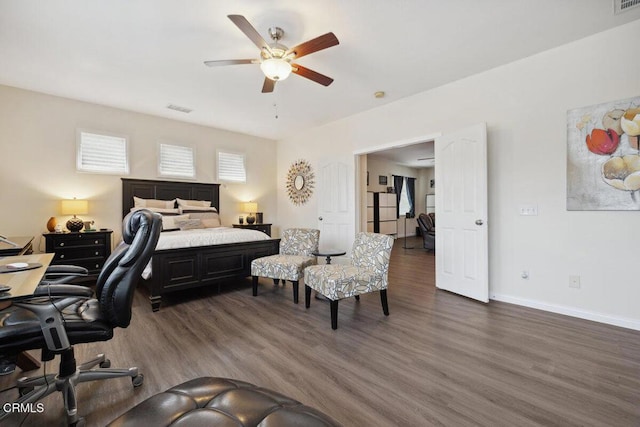 bedroom with ceiling fan and dark hardwood / wood-style floors