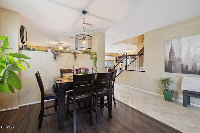 tiled dining space with ceiling fan