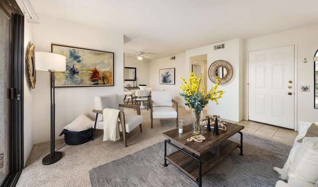 tiled living room with ceiling fan