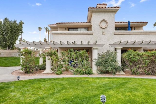 rear view of house with a pergola and a lawn