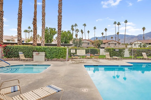 view of pool with a mountain view and a patio