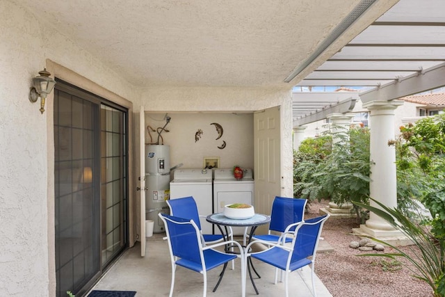 view of patio / terrace featuring washer and clothes dryer, water heater, and a pergola