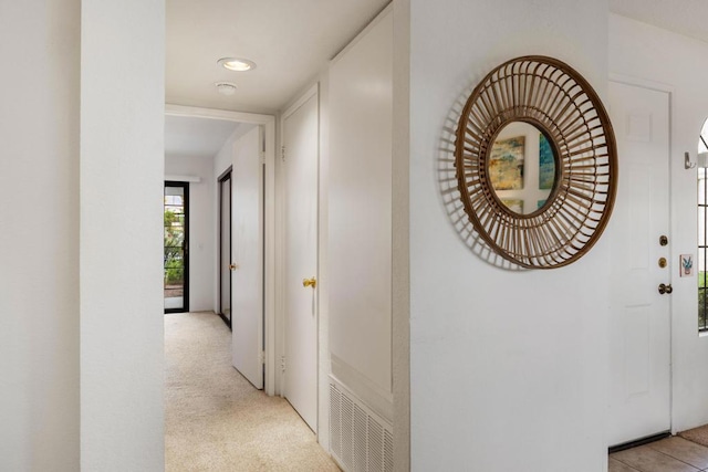 corridor with light colored carpet