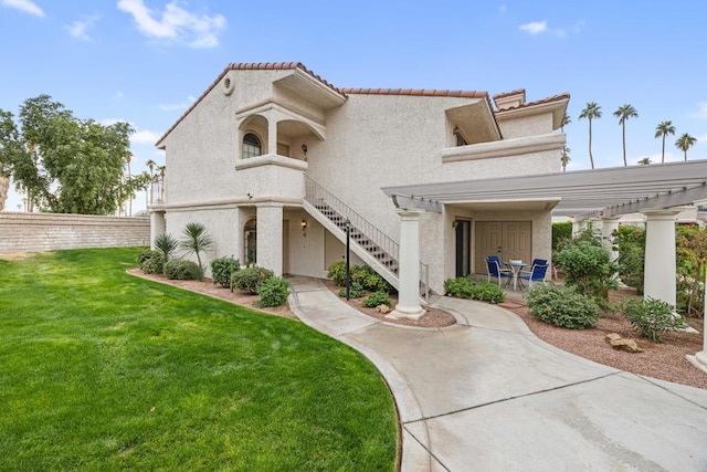 mediterranean / spanish-style home with a front lawn