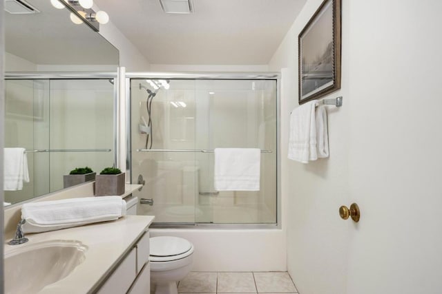 full bathroom featuring enclosed tub / shower combo, toilet, vanity, and tile patterned flooring