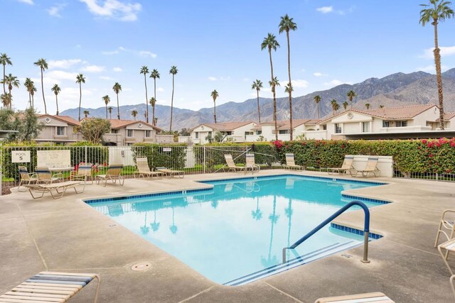 view of pool with a mountain view and a patio