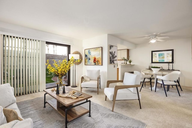 carpeted living room with ceiling fan