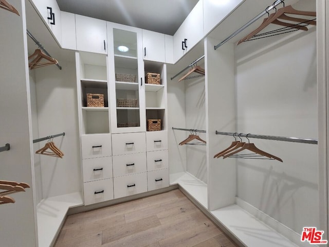 walk in closet featuring light hardwood / wood-style floors