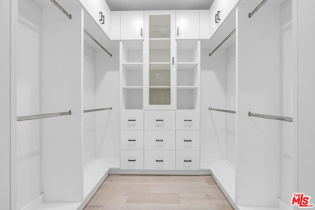 walk in closet featuring light hardwood / wood-style flooring