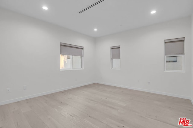 empty room with light hardwood / wood-style floors