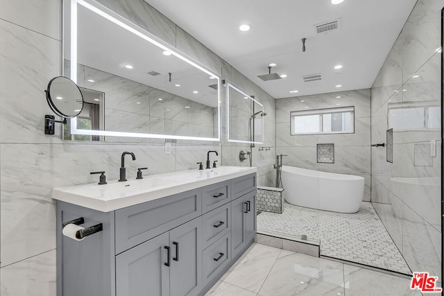 bathroom featuring independent shower and bath, tile walls, and vanity