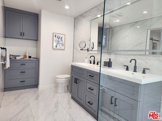 bathroom featuring a shower with door, tile walls, toilet, and vanity