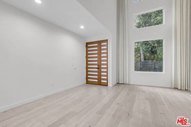 empty room with a healthy amount of sunlight and light wood-type flooring