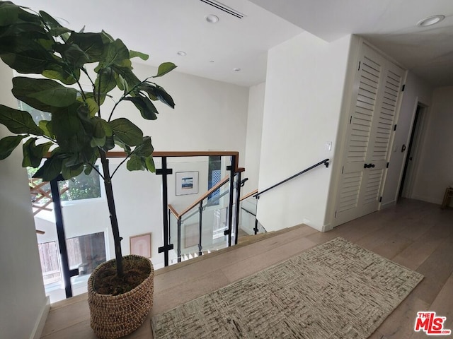 stairs featuring wood-type flooring