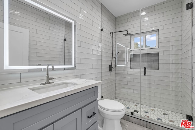 bathroom with toilet, tile walls, walk in shower, and vanity