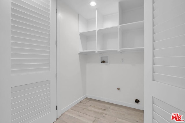 clothes washing area featuring light hardwood / wood-style flooring, hookup for a washing machine, and hookup for a gas dryer