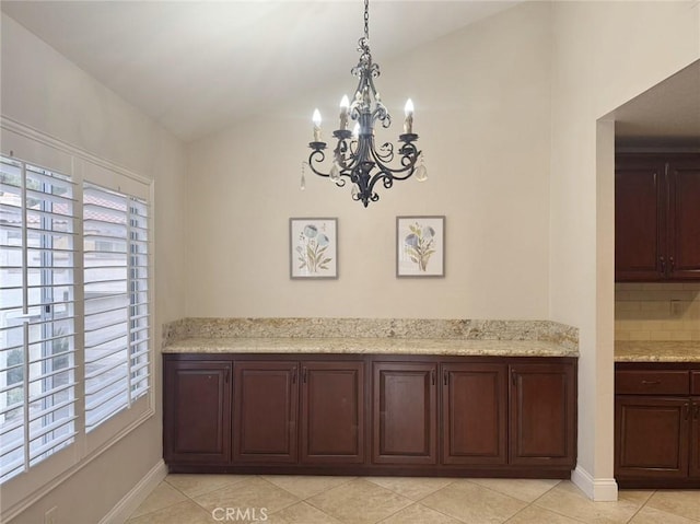 room details with backsplash and an inviting chandelier