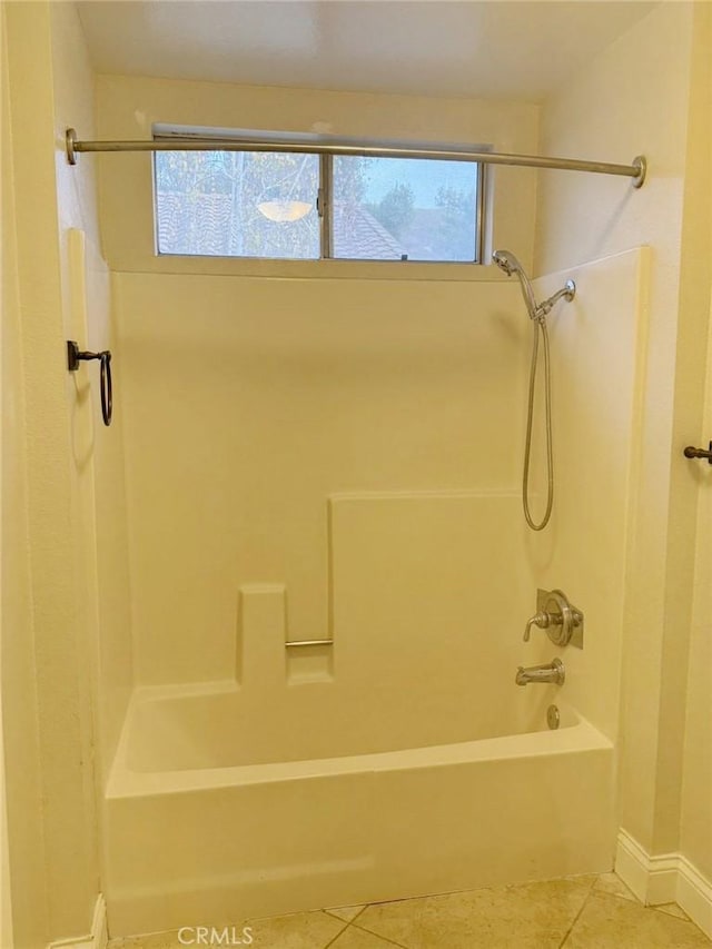 bathroom featuring tile patterned flooring and shower / bathtub combination