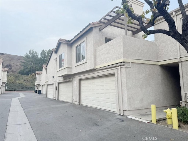 view of side of property with a garage and a mountain view