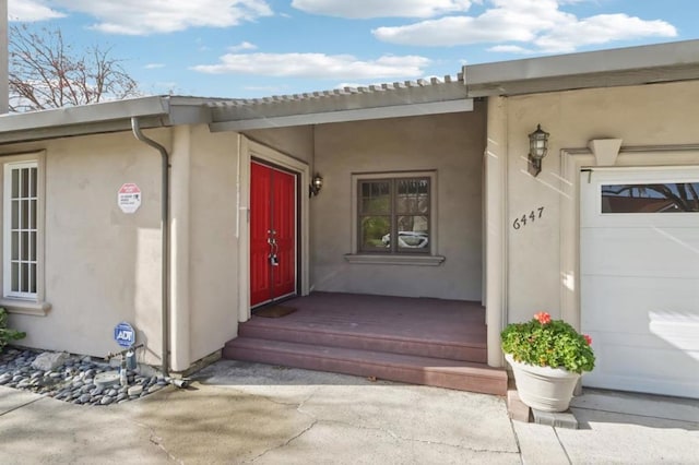 view of exterior entry featuring a garage