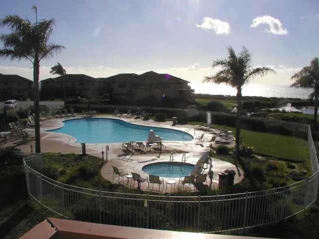 view of pool with a patio area and a hot tub