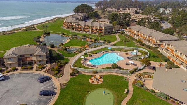 birds eye view of property featuring a water view and a beach view