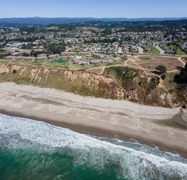 birds eye view of property with a beach view and a water view