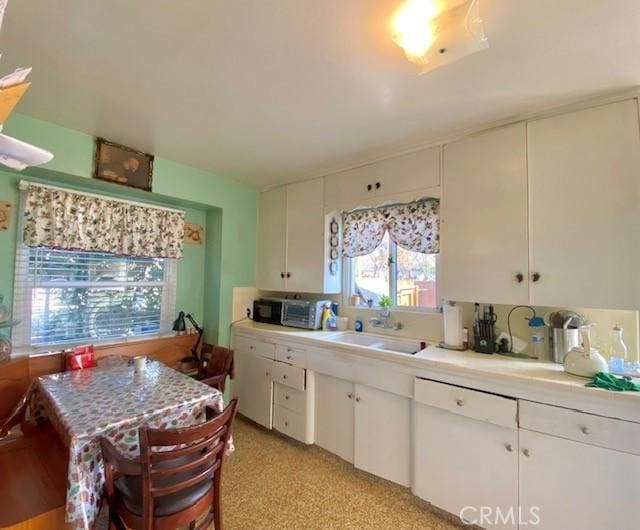 kitchen with sink and white cabinetry