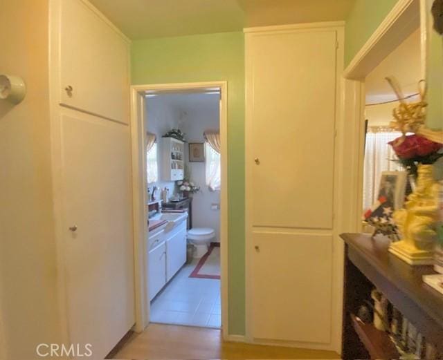 corridor featuring light tile patterned flooring