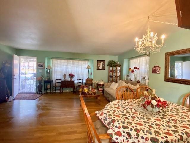 dining room featuring hardwood / wood-style floors and a chandelier