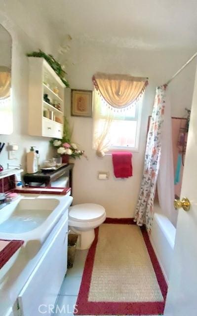 full bathroom featuring toilet, shower / bath combination with curtain, tile patterned floors, and vanity