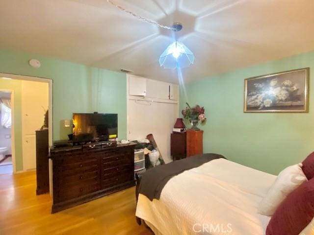 bedroom with a closet and light hardwood / wood-style floors