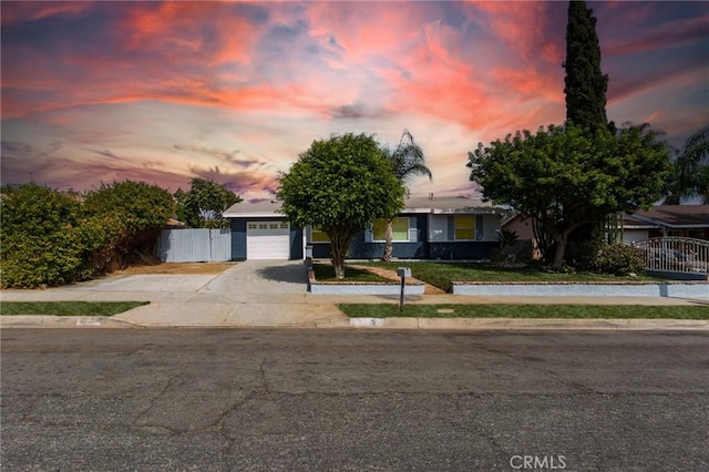 view of front of house with a gate, a garage, driveway, and fence