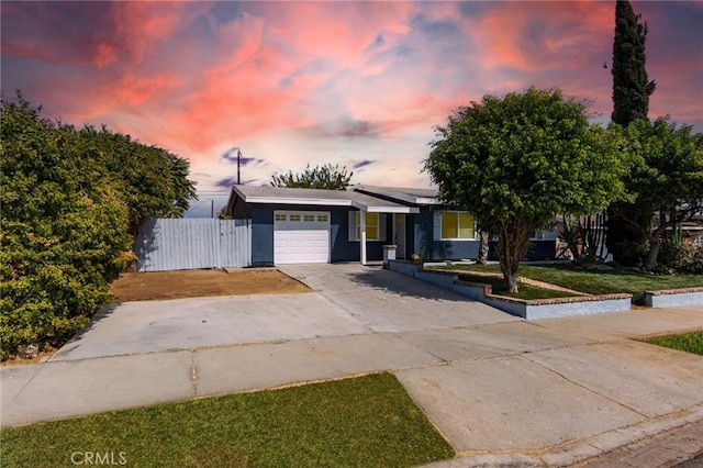 view of front facade featuring a garage and a lawn