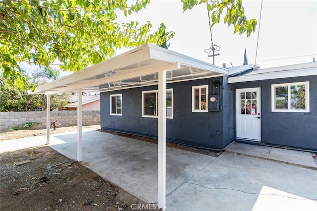 back of house with a patio area, stucco siding, and fence