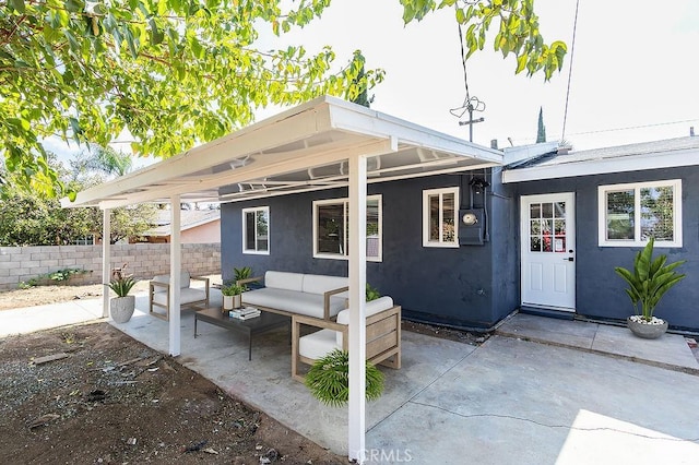 back of property featuring an outdoor living space, stucco siding, a patio, and fence