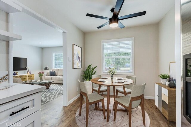 dining area featuring ceiling fan, a wealth of natural light, and light wood-type flooring