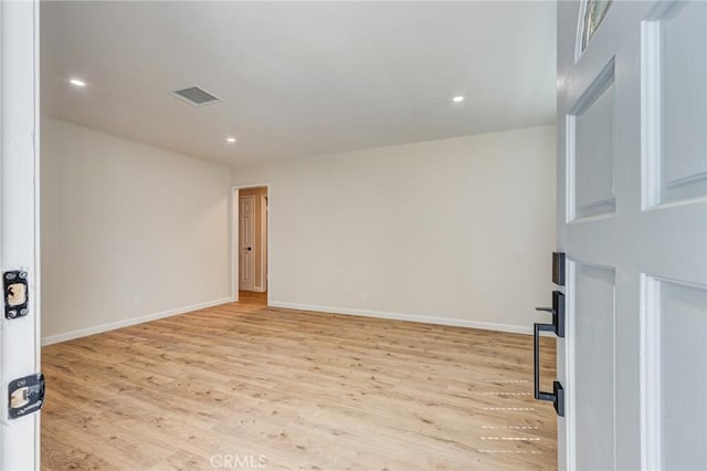 spare room with light wood-style flooring, recessed lighting, baseboards, and visible vents