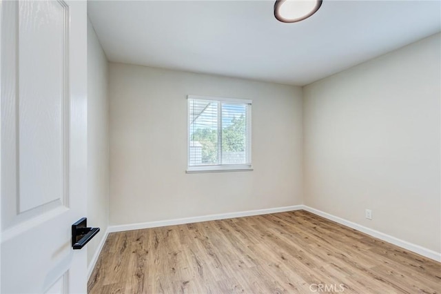 unfurnished room featuring light wood-type flooring and baseboards